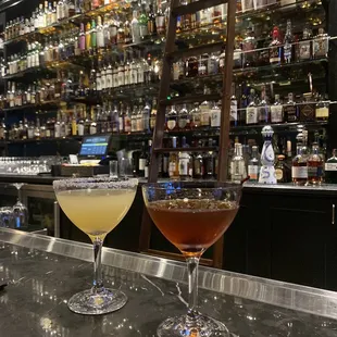 two cocktails on a bar