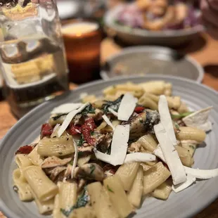 Rigatoni pasta with chicken, sun dried tomatoes, mushroom, greens, garlic- black pepper cream and Pecorini cheese.