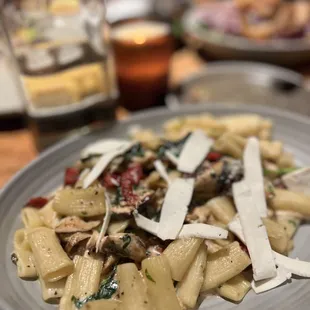 Rigatoni pasta with chicken, sun dried tomatoes, mushroom, greens, garlic- black pepper cream and Pecorini cheese.