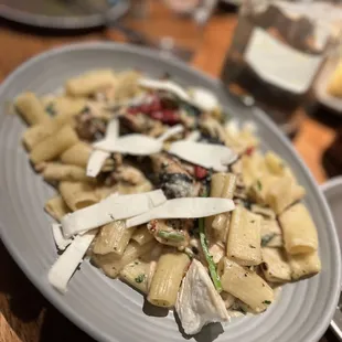 Rigatoni pasta with chicken, sun dried tomatoes, mushroom, greens, garlic- black pepper cream and Pecorini cheese.