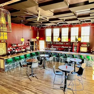 a view of a bar with a lot of stools and tables