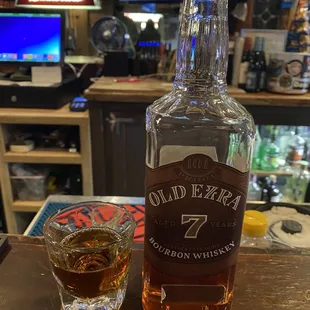 a bottle of old era 7 and a shot of whiskey