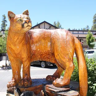 a carved cat on a tree stump