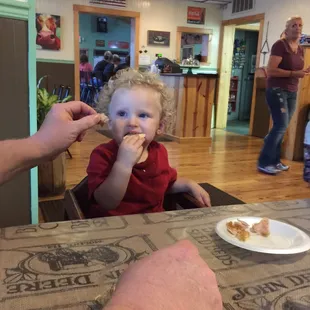 a toddler eating a donut