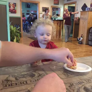 a toddler eating a donut