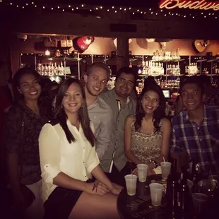 a group of people at a bar
