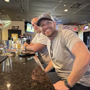two men sitting at the bar