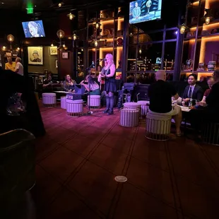 a group of people sitting at tables in a dimly lit room