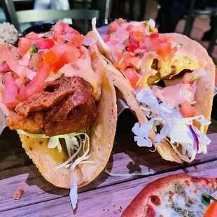 three tacos on a wooden table