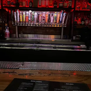 a bar with beer taps and menus