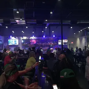 a crowd of people at a bar
