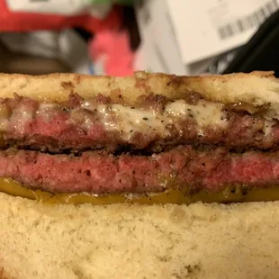 Cold bacon cheeseburger, nearly cooked