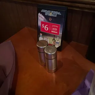a table with a menu and two cups on it