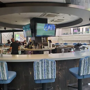 a bar with blue chairs