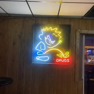 a neon sign in a bar