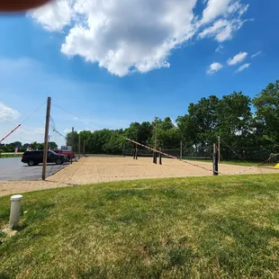 Three beautifully groomed volleyball courts.