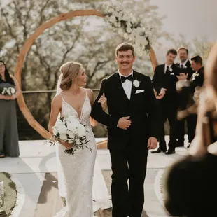 Couple shown in front of our circle arbor