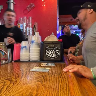 two men sitting at a bar