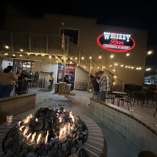 a fire pit in front of a restaurant
