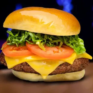 a cheeseburger with tomatoes and lettuce