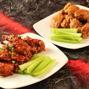 two plates of wings and celery