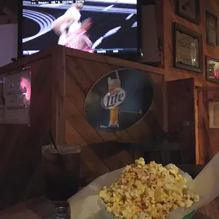 a basket of popcorn in front of a television
