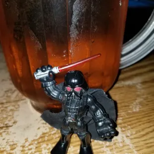 a toy figure holding a light saber