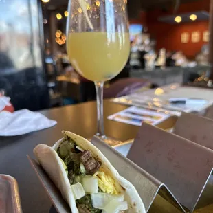 Their steak and eggs breakfast burrito and a mimosa
