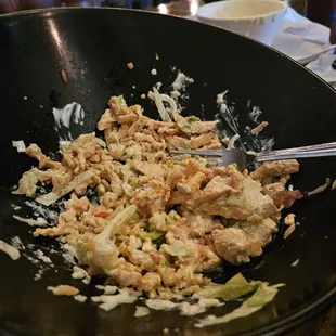 a bowl of food with a fork in it