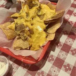 NACHOS: The waiter claimed the nachos were very good. It was a pile of chips with a whole chicken breast slapped on top with cheese sauce