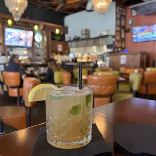 a glass of lemonade with a slice of lemon