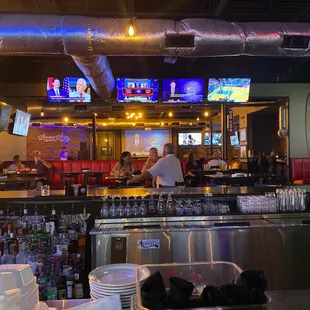 a view of the bar and televisions