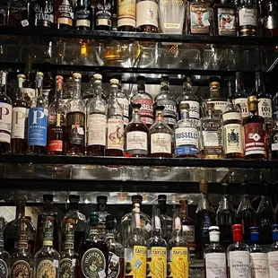 a shelf full of liquor bottles