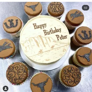 a birthday cake surrounded by cupcakes