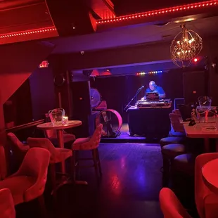 a bar with a dj in the background