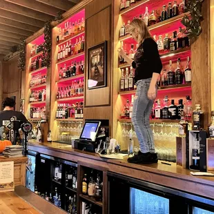 a woman standing at a bar