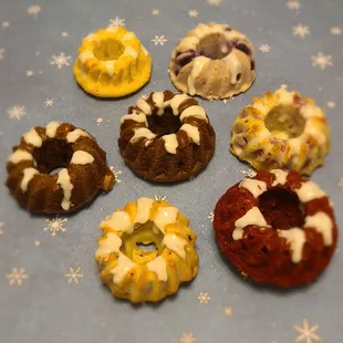 Mini bundt cake assortment! Chocolate, red velvet, vanilla, chocolate coconut, orange cranberry, ginger raspberry, and lemon blueberry.