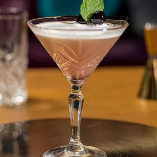 a drink in a martini glass on a table
