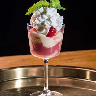 a dessert with whipped cream and strawberries