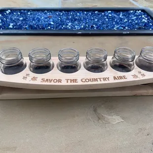 six glasses of wine on a wooden stand
