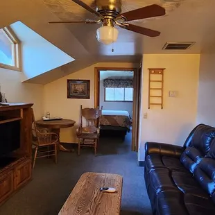 Good sized living room with a small dining table and fireplace