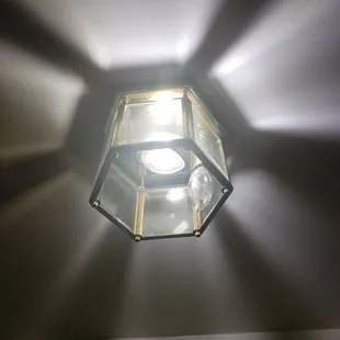 Old outdated lighting...with one bulb not working.