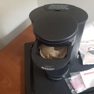 Coffee maker with old used coffee pod left from previous guest.