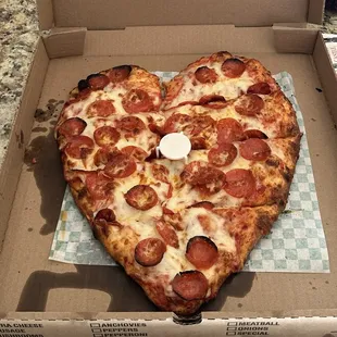 Heart shaped pepperoni pizza for Valentine&apos;s Day