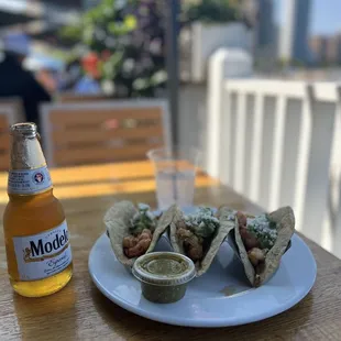 a plate of food and a bottle of beer