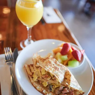 a plate of food and a glass of orange juice