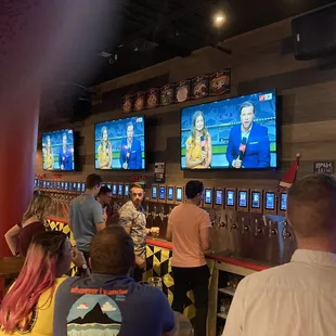 a large group of people watching televisions
