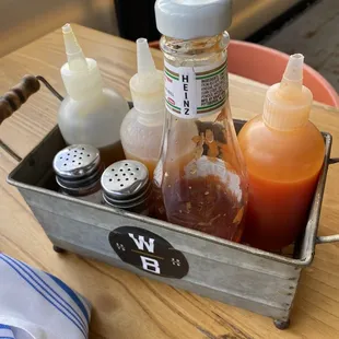 Sauces given to the table - honey, housemade Tabasco  sauce, habanero hot sauce
