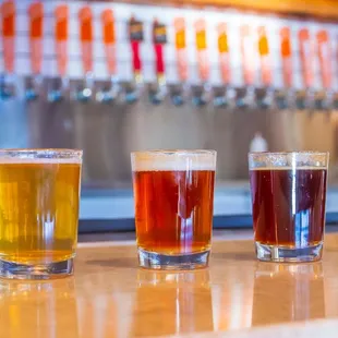 a row of beers on a bar