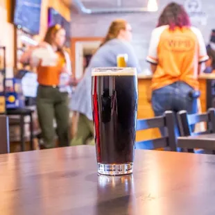 a pint of beer on a table